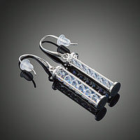 Close up of KHAISTA candle shape crystal drop earrings