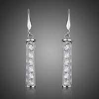 KHAISTA candle shape crystal drop earrings on white background