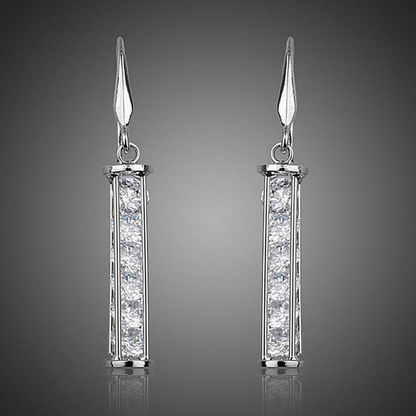 KHAISTA candle shape crystal drop earrings on white background