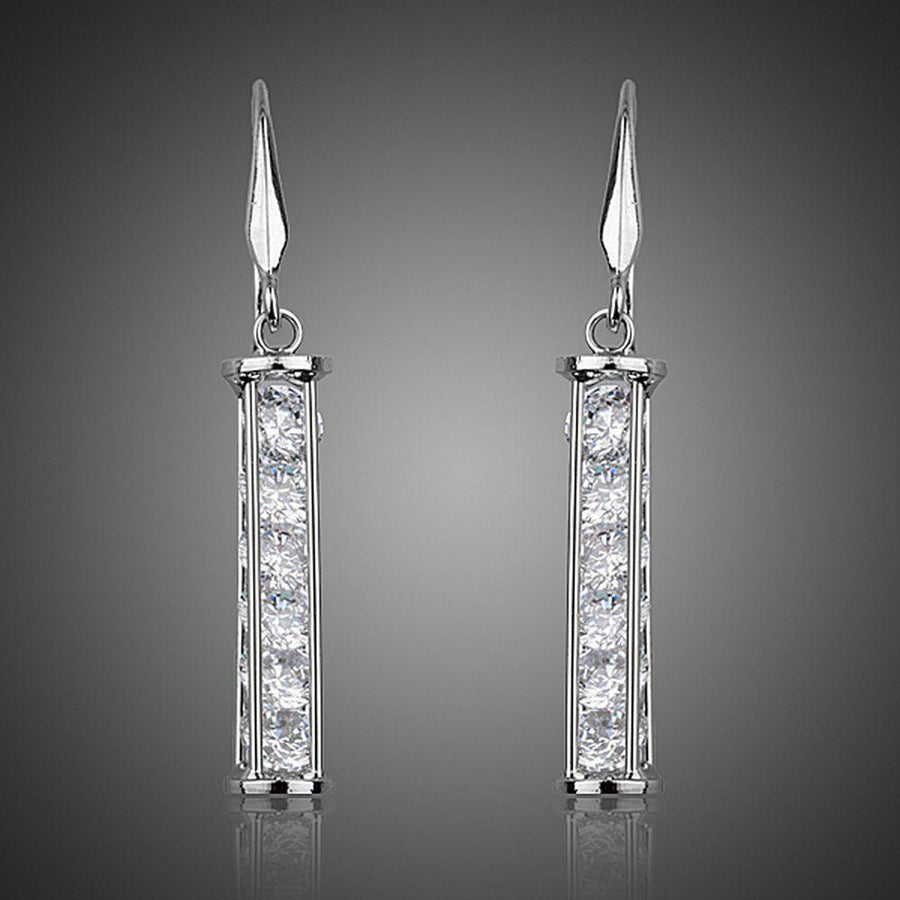 KHAISTA candle shape crystal drop earrings on white background