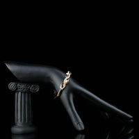 Side angle view of KHAISTA caramel crystal wave bangle