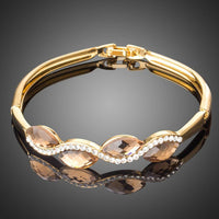 KHAISTA caramel crystal wave bangle on white background