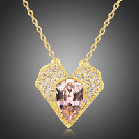 Close up detail of KHAISTA champagne Austrian crystal vintage heart necklace