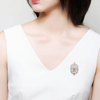 Side angle view of Khaista champagne zircon brooch