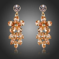 KHAISTA champagne crystal cluster drop earrings on white background