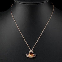 Close up detail of KHAISTA champagne crystal crab pendant necklace