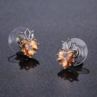 Close up of KHAISTA champagne cubic zirconia earrings