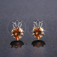 Side angle view of KHAISTA champagne cubic zirconia earrings