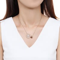 Side angle view of KHAISTA champagne CZ snowflake pendant necklace
