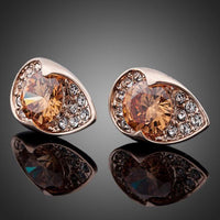 Close up of KHAISTA champagne CZ stud earrings