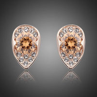 KHAISTA champagne CZ stud earrings on white background