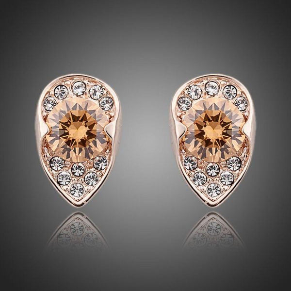 KHAISTA champagne CZ stud earrings on white background