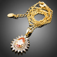 Side angle view of KHAISTA champagne CZ sunflower pendant necklace