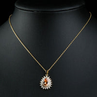 Close up detail of KHAISTA champagne CZ sunflower pendant necklace