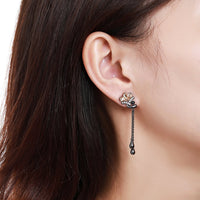 Close up of KHAISTA champagne crystal flower drop earrings