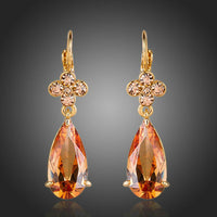 KHAISTA champagne flower CZ hanging earrings on white background