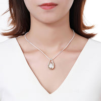 Side angle view of KHAISTA champagne pear shape crystal necklace