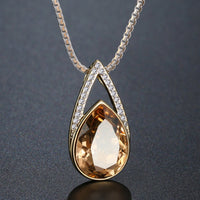 Close up detail of KHAISTA champagne pear shape crystal necklace