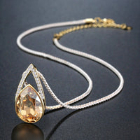 Pendant detail on KHAISTA champagne pear shape crystal necklace