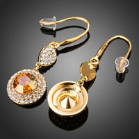 Close up of KHAISTA champagne round crystal drop earrings