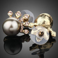 Close up of KHAISTA chocolate pearl crown stud earrings