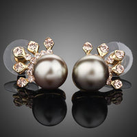 KHAISTA chocolate pearl crown stud earrings on white background