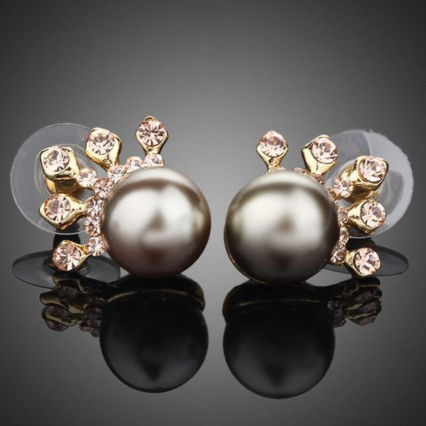 KHAISTA chocolate pearl crown stud earrings on white background