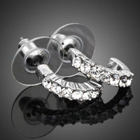 Close up of KHAISTA classic crystal stud earrings