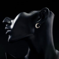 Side angle view of KHAISTA classic crystal stud earrings