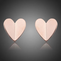 KHAISTA classic gold heart stud earrings on white background