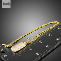 Pendant detail on KHAISTA classic gold chain necklace