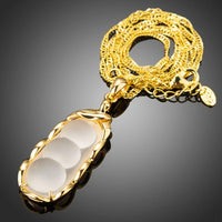 Side angle view of KHAISTA classic gold chain necklace