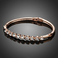 Close up detail of KHAISTA classic rose gold crystal bangle
