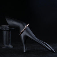 Side angle view of KHAISTA classic rose gold crystal bangle