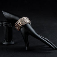 Side angle view of KHAISTA classic rose gold cuff bangle