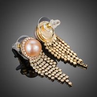 Close up of KHAISTA claw chain pearl earrings