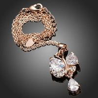Side angle view of KHAISTA clear CZ pendant necklace