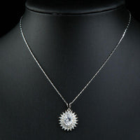 Close up detail of KHAISTA clear CZ sunflower necklace