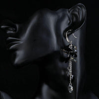 Side angle view of KHAISTA cluster crystal drop earrings