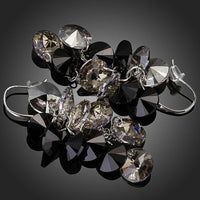 Close up of KHAISTA cluster crystal drop earrings