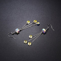 Close up of KHAISTA colour change raindrop dangle earrings