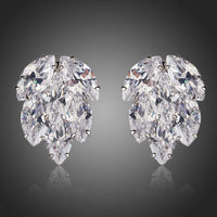 KHAISTA coupled CZ cluster stud earrings on white background