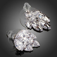 Close up of KHAISTA coupled CZ cluster stud earrings