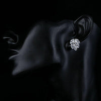 Side angle view of KHAISTA coupled CZ cluster stud earrings