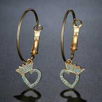 Close up of KHAISTA crown heart crystal dangle earrings