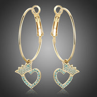 KHAISTA crown heart crystal dangle earrings on white background