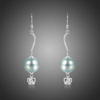 KHAISTA crown pearl drop earrings on white background