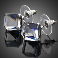 KHAISTA crystal blue square stud earrings on white background