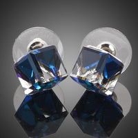 Close up of KHAISTA crystal blue square stud earrings