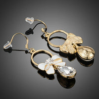 Close up of KHAISTA crystal bow knot drop earrings